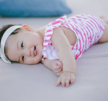 Baby lying on daybed during family photography session at Sofitel Nusa Dua Bali