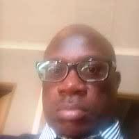 a man in a suit and tie with glasses
