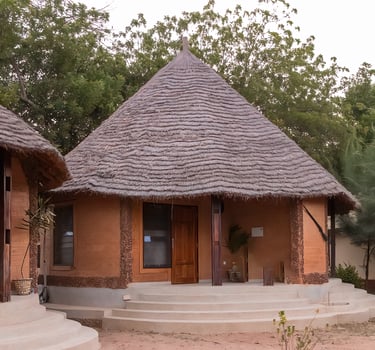 A scenic view of Tendaba Camp in Kwinella, situated along the peaceful riverbank and surrounded by l