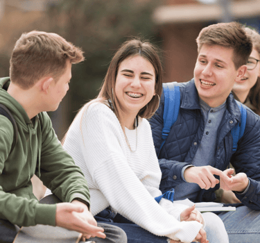 a group of young people sitting on a bench