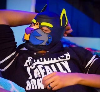 Man in a pup mask.