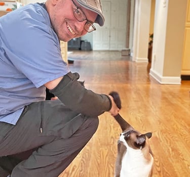 a veterinary and a cat on a hardwood floor