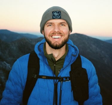 Nate Bowery standing in front of the Great Smoky Mountains during a winter hike