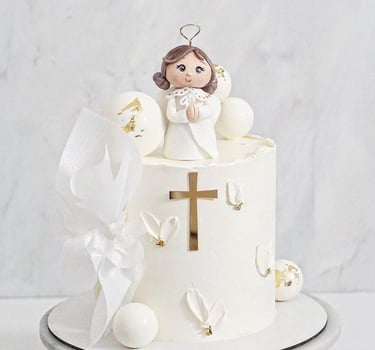 a cake with a little angel on top of it