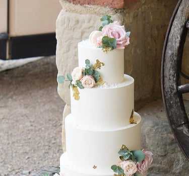 a wedding cake with flowers on top of it
