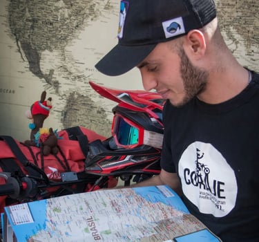 a man in a black shirt and a map of a motorcycle