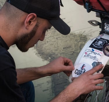 a man in a cap is working on a bike