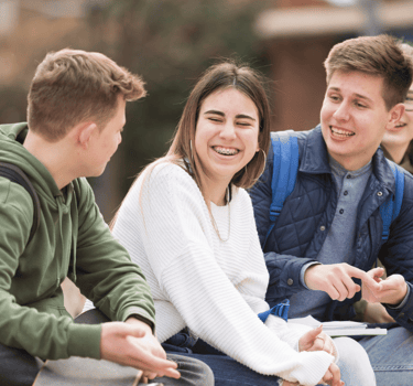 a group of young people sitting on a bench