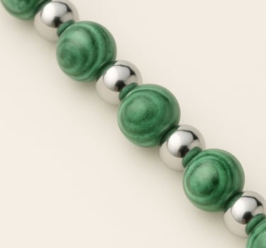 a green beaded bracelet bracelet with a silver ball