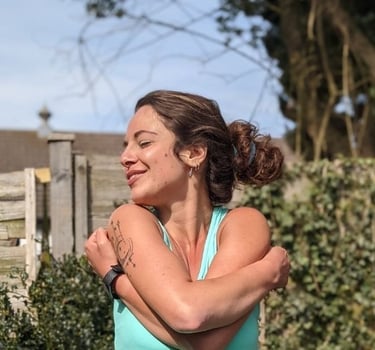 a woman in a blue tank top and a black watch on her wrist