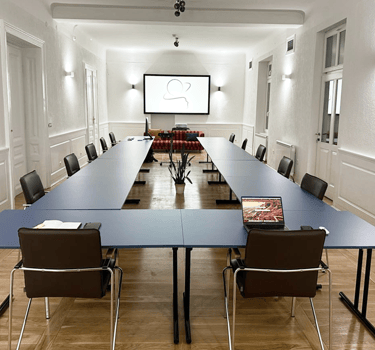 a conference room with a long table and chairs