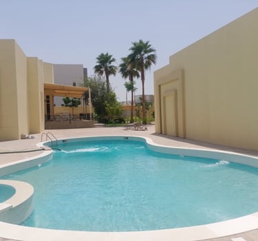 a pool with a swimming pool and a lounge area