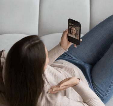 a woman is taking a selfie with her phone