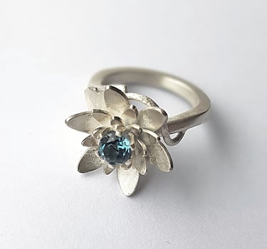 a ring with a flower in the middle of it