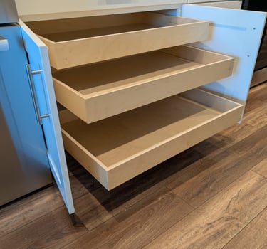 Triple  roll-out shelves in a base cabinet significantly increase storage space.