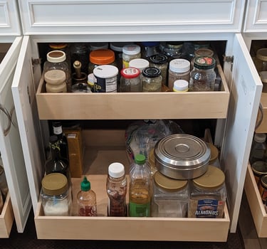 Pull out shelving in a kitchen cabinet for maximum convenience.