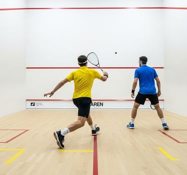 two mens playing squash