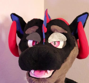 A dragon head made by Teto Creations featuring large curly horns, expressive moving eyelids and silicone teeth