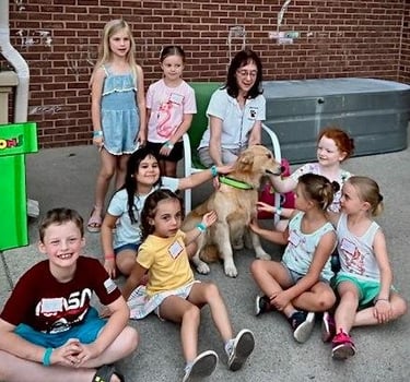Kids visiting with Pet Partners Therapy Dog Team Ana and Lori.