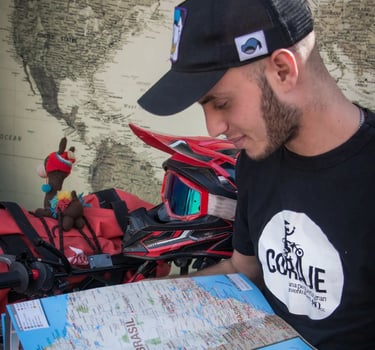 a man in a black shirt and a map of a motorcycle