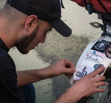 a man in a cap is working on a bike