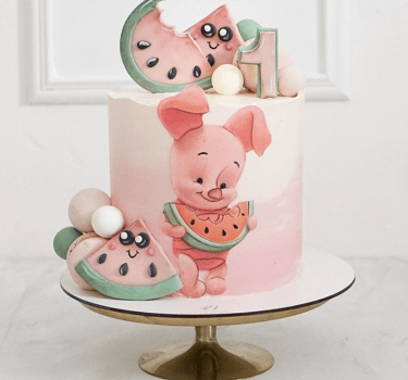 a cake with a piggy and a watermelon