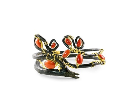 a pair of rings with red and black enamel