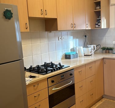 a kitchen with a stove top oven and a refrigerator