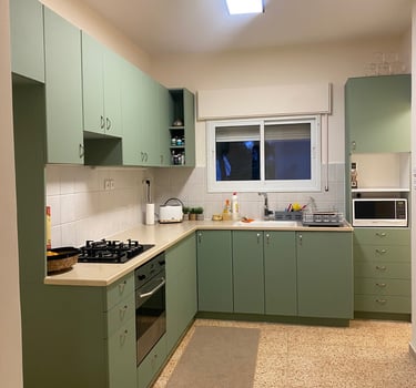 a kitchen with a green kitchen with a white counter top