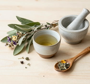 a table with a bowl of soup and a jar of herbs