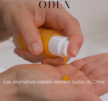 a person holding a bottle of liquid of cosmetic in their hand