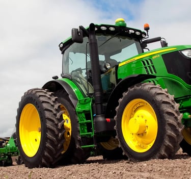 a tractor with a tractor in the middle of a field