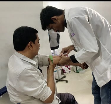 Lab assistant collecting blood sample from patient at Asian Diabetes Center Madinaguda Hyderabad