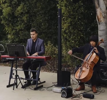 Pianist Daine Jordan and cellist Hitoshi Suzuki play together on a wedding gig