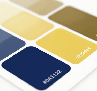 Close-up of a color palette swatch including #0A1128 and #E2B941, presented as abstract architectural shapes. Lighting is soft and professional, emphasizing design precision.