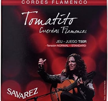 a man playing guitar in front of a microphone