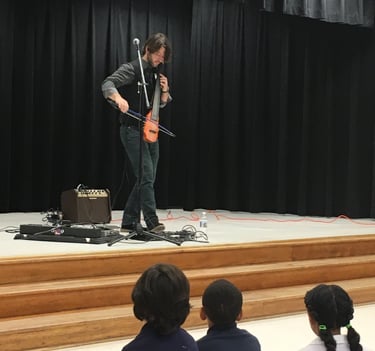 cellist Wytold performs at a school