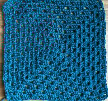 Two granny squares—one twisted, one flat after turning rounds.