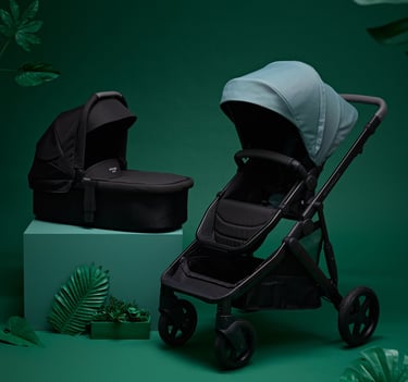 Product campaign photography - a baby stroller and a baby carrier on a green background