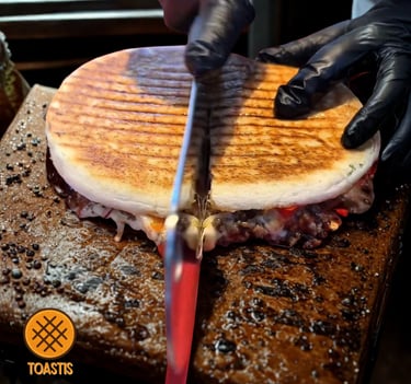 a person in gloves and gloves cutting a sandwich Toastis, Toastup