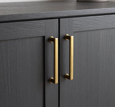 Close-up detail of a custom-made cabinet in dark slate wood, featuring minimalist brass handles, captured in a South American / Brazilian residential setting with sharp focus and professional studio lighting.