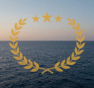 An organic, serene photograph of the Mediterranean coastline at dusk. The water is a deep blue and the sky is a soft pearl color, capturing the inspiration behind the artist's work.