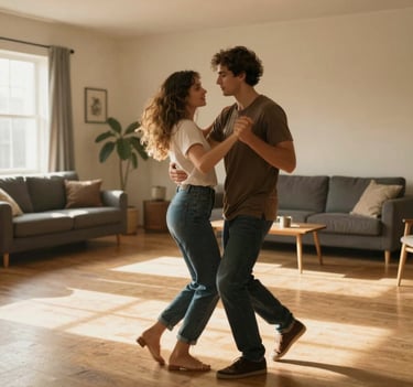 A wide-angle, cinematic shot of a young couple dancing in a sun-filled North American / US living room. Authentic emotion, slightly blurred motion for a candid feel. Background features Soft Sand walls and Charcoal furniture accents with golden sunlight streaming in.