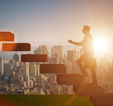 Businessman in a suit with a briefcase climbing concrete steps towards a bright sunset, symbolizing career progression and