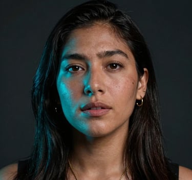 A close-up portrait of a South American / Colombian singer in a dark studio, illuminated by a soft neon cyan light on one side. Emotional expression, cinematic urban style.