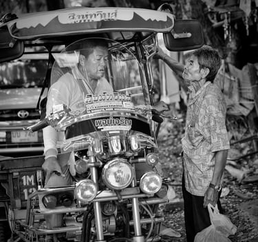 Skylab driver discussing fare with passenger in Thailand - street photography by Peter Pickering