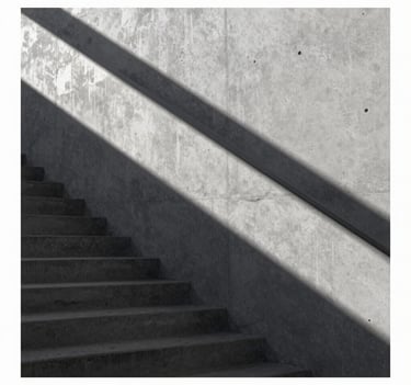 Vertical shot of a concrete staircase with long, geometric shadows of the handrail. High contrast using #2F363F and #D0D5DB tones, refined and understated.