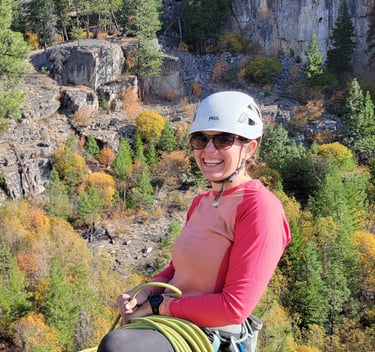 Nat smiling at the top of a climb in Skaha