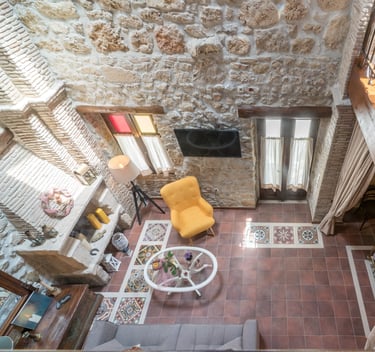 open space interior of two floor stone house Villa Galanoussa Zakynthos