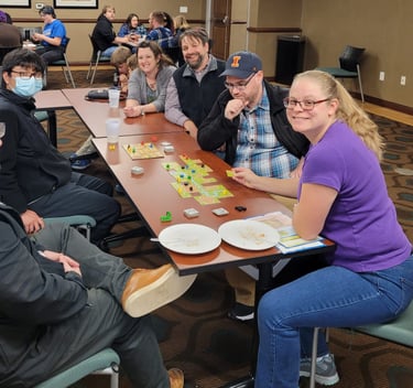 Dr. Hooton, history faculty, and students playing board games.